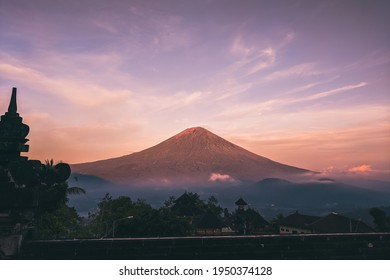 mountain view surrounded by clouds in the afternoon. this mountain is in bali.bali sunset