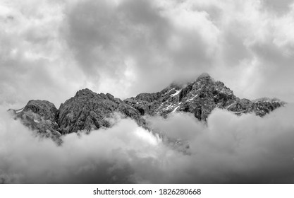 mountain view of Zugspitze from Eibsee lake with high peaks breaking through dramatic clouds in Bavaria, Germany
