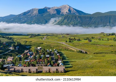 Mountain Village - A Foggy Summer Morning View Of Mountain Town Crested Butte At Base Of Whetstone Mountain. Colorado, USA. 