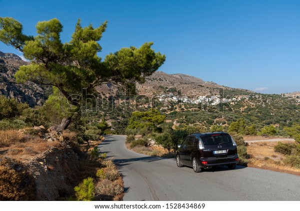 Mountain village of  Pefki seen from Agios\
Stefanos road, Crete, Greece. September 2019.  The mountainside\
ancient village of Pefki on the\
mountainside.