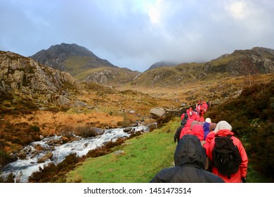 Mountain Walking In Group At Snowdonia, Wales During Winter