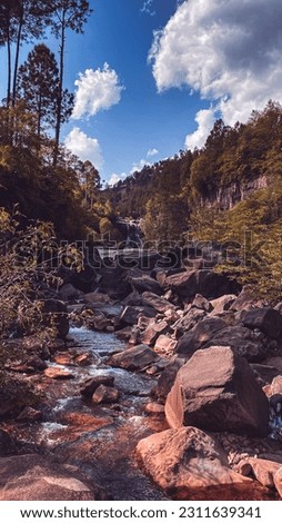 Mountain waterfall in Under Beautiful Sky and Forest Trees,Water stones.