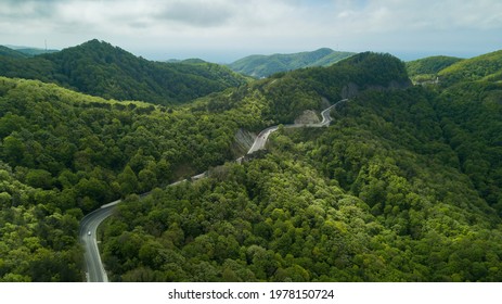 Mountain winding zig zag road. Top aerial view: cars driving on road from above. - Powered by Shutterstock