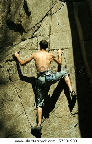 Similar – Rock climber clinging to a cliff.