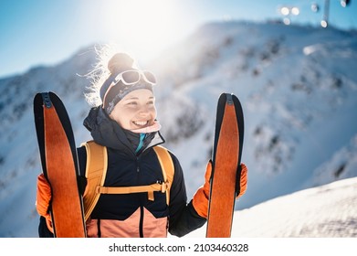 Mountaineer backcountry ski walking ski alpinist in the mountains. Ski touring in alpine landscape with snowy trees. Adventure winter sport. - Shutterstock ID 2103460328