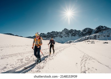 Mountaineer backcountry ski walking ski alpinist in the mountains. Ski touring in alpine landscape with snowy trees. Adventure winter sport. High tatras, slovakia landscape
