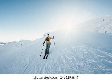 Mountaineer backcountry ski walking ski alpinist in the mountains. Ski touring in alpine landscape with snowy trees. Adventure winter sport. Low Tatras, slovakia - Powered by Shutterstock