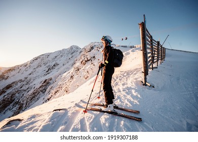 Mountaineer backcountry ski walking in the mountains. Ski touring in high alpine landscape. Adventure winter extreme sport. Sunny day