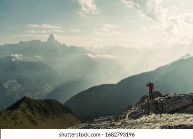 Mountaineer With Backpack On Rock Enjoying View Of Big Mountains, Hiking Lifestyle, Man On Top. Retro Film Filter, Vintage Stylization