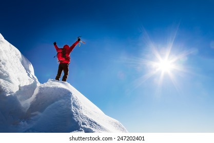 Mountaineer celebrates the conquest of the summit. Concepts: victory, success, achievement, triumph.  