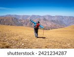 Mountaineer man achieving his goal. Happy man with his arms stretched out in front of an immense mountain of colors. Colorful mountains in northern Argentina. 