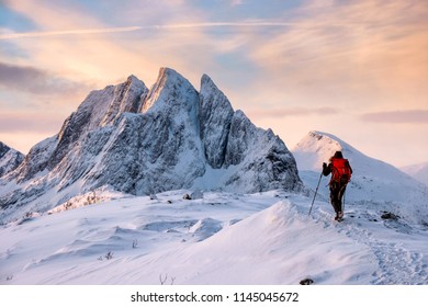 Mountaineer Man Climbs On Top Snowy Mountain With Colorful Sky In Morning