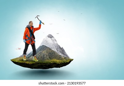 Mountaineer reaches the top of a snowy mountain