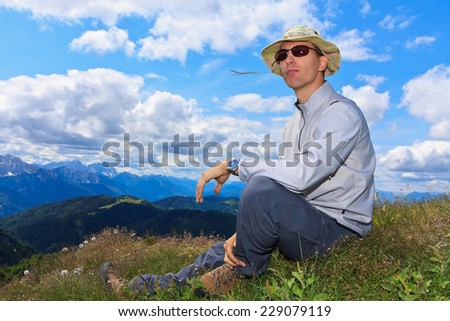 Similar – young man with hat in front of mountain panorama