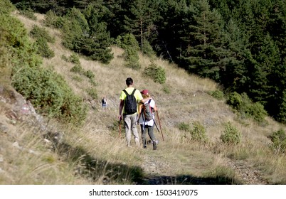 a mountaineers couple walking down a hill