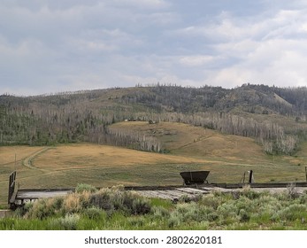 Mountainous area in front of a mining contraption, some sort of dump area for rocks or something