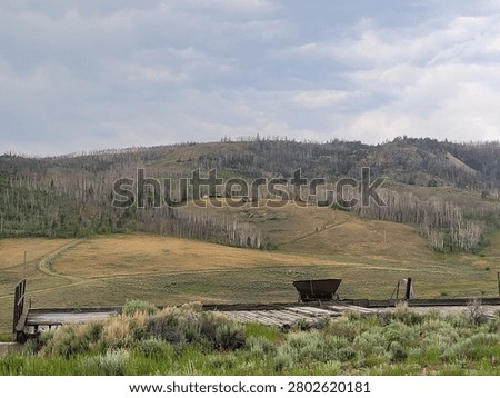 Mountainous area in front of a mining contraption, some sort of dump area for rocks or something