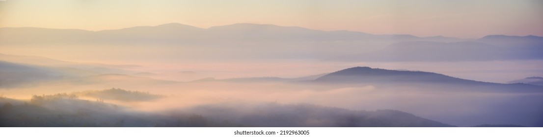 mountainous countryside landscape at sunrise. cloud inversion in the distant valley. fog among the rolling hills glowing in morning light. wonderful nature background in autumn season - Powered by Shutterstock