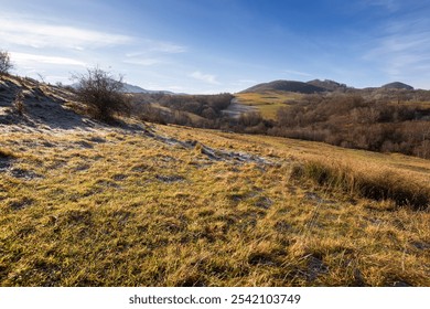 mountainous countryside landscape of ukraine in autumn. leafless trees on a sunny morning. grassy meadows and forested hills. volovets district in fall season - Powered by Shutterstock