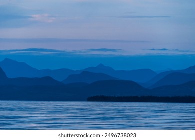 Mountainous landscape conveying a blueish hue. - Powered by Shutterstock