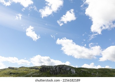 mountainrange under a blue sky with some clouds