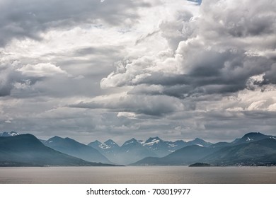 Mountains along the Romsdalsfjorden near Andalsnes under a cloudy sky, Norway - Powered by Shutterstock