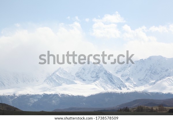 Mountains. Beautiful russian nature of Altai Krai,\
Russia. Forests and mountains with snowy peaks. Landscape, view,\
scenery, landmark of Altai Krai, Russia. Tourism, travel in Altai\
Krai. Altai hiking