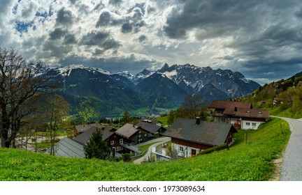 The mountains between Vorarlberg and Graubünden while the foehn collapses and rain clouds break in over the valley and the villages. lighted and dark clouds are dramatic. snowy Austrian alps in spring - Powered by Shutterstock