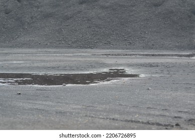 Mountains Of Black Coal In A Concept Of Energy Crisis And Energy Shortage In The Foreground Puddles