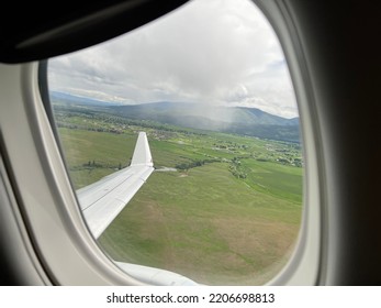 Mountains, Clouds, And Aircraft Wing, Seen Through Passenger Jet Window While Taking Off From Missoula Montana Airport