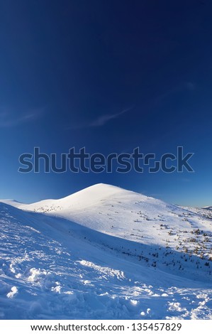 Mountains and dark sky at the winter time. Beautiful landscape