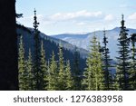 Mountains in the distance have shadows stretched across them in Kootenai National Forest in Montana.