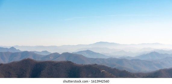 The mountains of Korea have become impressive landscapes due to the blue sky and fog. - Shutterstock ID 1613942560