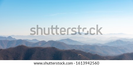 The mountains of Korea have become impressive landscapes due to the blue sky and fog.