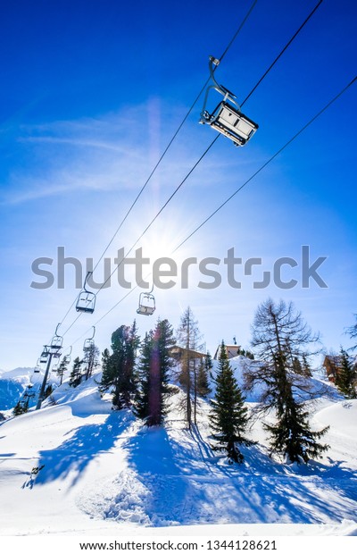mountains with modern ski\
lift chairs