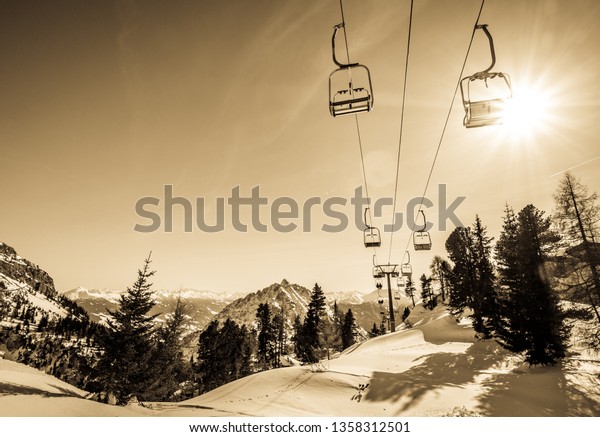 mountains with modern ski\
lift chairs