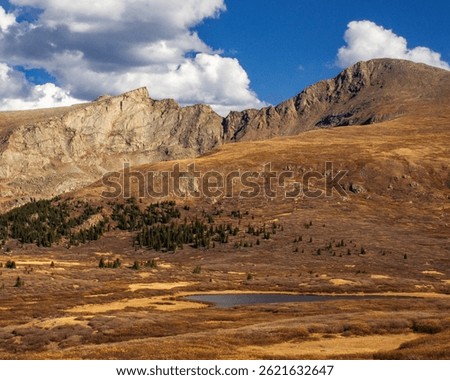 Mountains with pond in front in Autumn