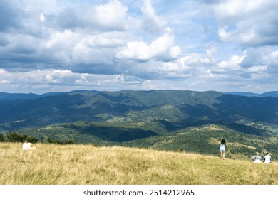 Mountains ranges in the Carpathians. Hills, forest and meadows. Green valley. Cloudy sky Ukraine - Powered by Shutterstock