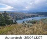 Mountains and rolling hills overlooking river at sunrise