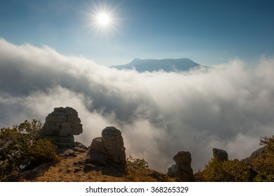 Mountain's scene with sun over clouds on mountains range