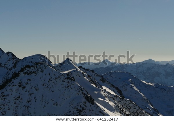 Mountains with\
snow, picture divided by horizon\

