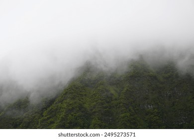 Mountainside of Mount Ka’Ala with low lying clouds