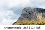 A mountaintop surrounded by clouds.