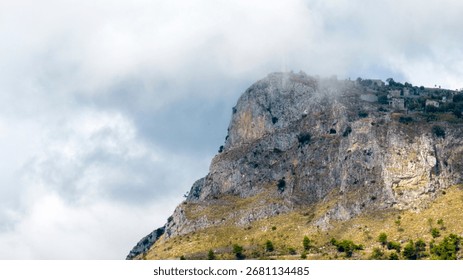 A mountaintop surrounded by clouds.
