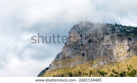 A mountaintop surrounded by clouds.