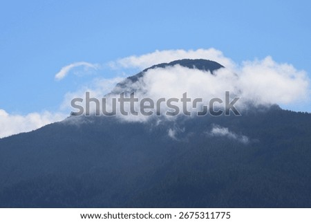 Mountaintop surrounded by ring of clouds