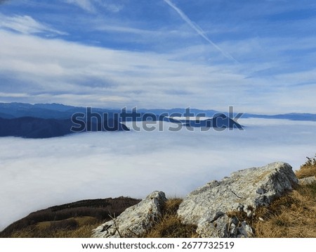 Mountaintops above clouds and rocks
