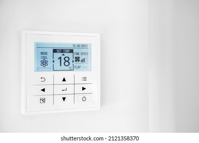 Mounted On Wall, Climate Control Show 18 Degrees Indoor, Remote Air-conditioner Inside Smart Home Close Up View, No People. Modern Tech, Comfort Living Concept