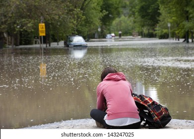 Mournful Calgary Resident Hopelessly Viewing Her Flooded Home And Vehicle; Calgary Flood 2013 