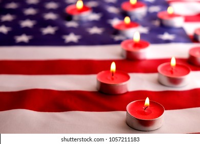 Mourning Candles Burning On USA American National Flag Background. Memorial Weekend, Patriot Veterans Day, 9/11 National Day Of Service & Remembrance. Moment Of Silence Concept. Close Up, Copy Space.